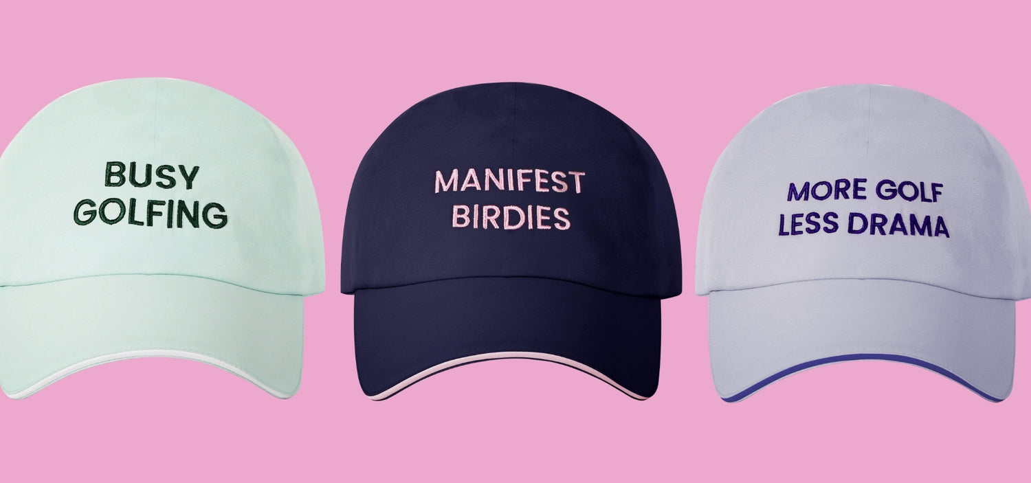 Three baseball caps with humorous text on a pink background